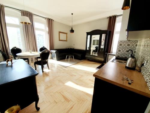 a living room with a kitchen and a living room with a table at Classic Apartments - Top Location, bezpłatny parking in Ełk