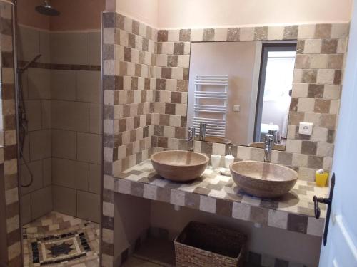 two sinks in a bathroom with a mirror at Casa Myrta 3 étoiles in Porto-Vecchio