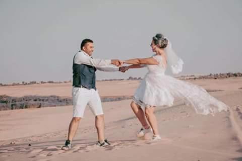 a bride and groom dancing on the beach at Tunis Village Chalet in Fayoum Center