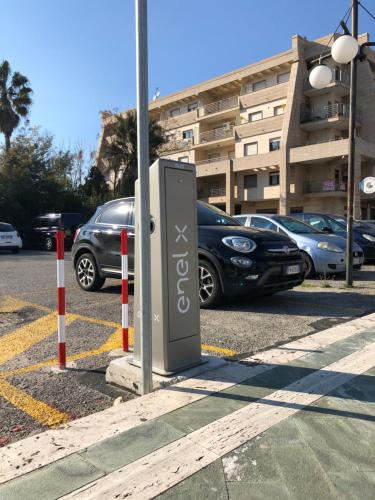a parking meter in a parking lot with parked cars at B&B Rossini Luxury in Rende