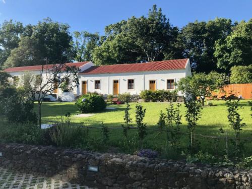 a white house with a red roof at #Areias Houses 9 in Furnas