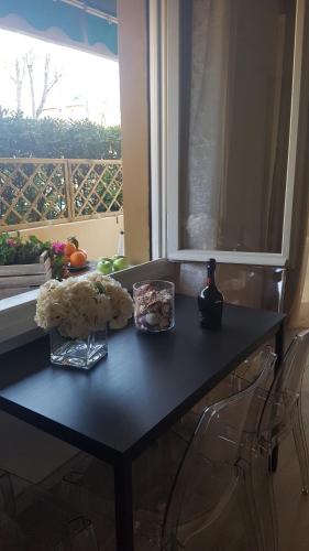 a black table with food on it with a window at Versilia Apartment in Forte dei Marmi