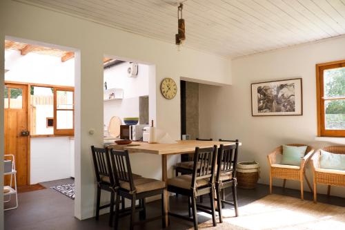 a kitchen and dining room with a table and chairs at #Areias Houses 9 in Furnas