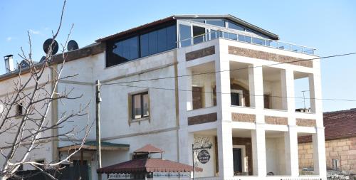 a white building with a window on top of it at EL NAZAR STONE SUİTE in Uchisar