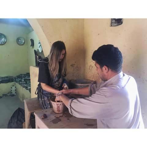 a man and a woman preparing food in a kitchen at Tunis Village Chalet in Fayoum Center