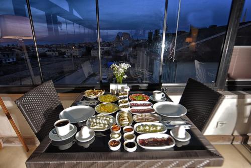 a table with a bunch of pastries on it at EL NAZAR STONE SUİTE in Uchisar
