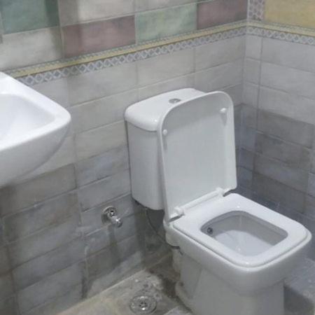 a bathroom with a white toilet and a sink at De La Poste in Port Said