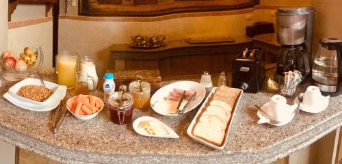 a counter top with a bunch of food on it at Hotel Boutique Mansion Del Rio in Guayaquil