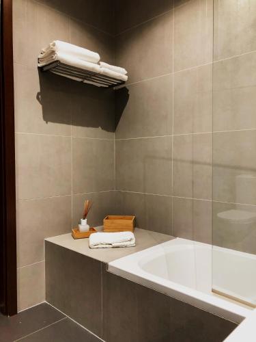 a bathroom with a bath tub and a sink at Cavalo Preto Luxury Beach Resort - C201 in Quarteira