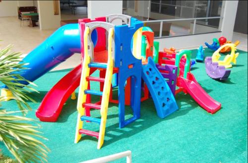 a playground with a slide in a room at Apartamento Veredas do Rio Quente - 919 in Rio Quente