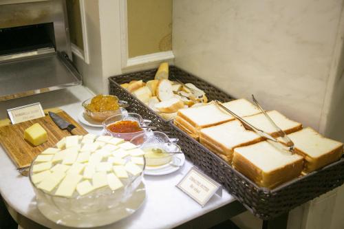 a buffet with cheese and other foods on a table at CityBay Palace Hạ Long Hotel in Ha Long