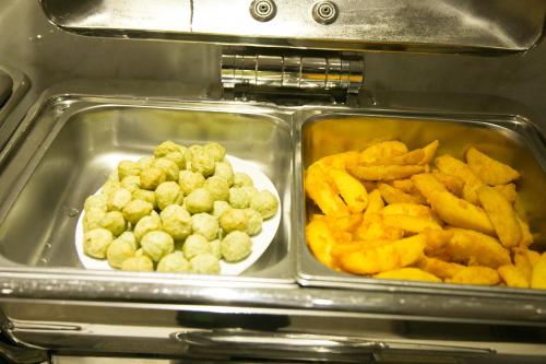a tray of food with a plate of french fries at CityBay Palace Hạ Long Hotel in Ha Long