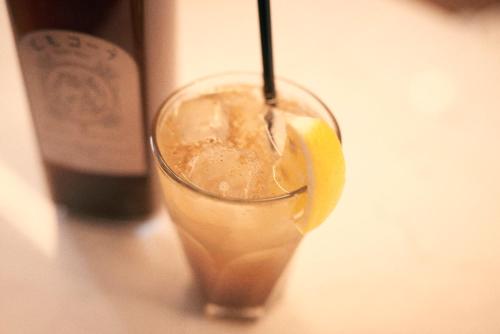 a drink with a lemon and a bottle of wine at Hotel She, Kyoto in Kyoto
