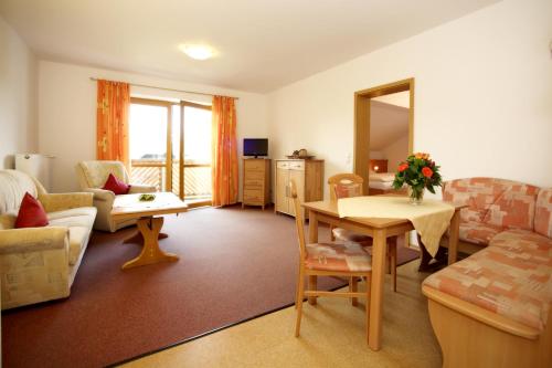 a living room with a couch and a table at Appartementhaus Albrecht in Bad Füssing