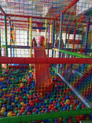 a person in a play center filled with balls at Hotel Avangarda in Różan