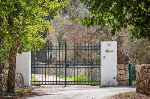 a gate with a white refrigerator in front of a fence at torre casciani in Ugento