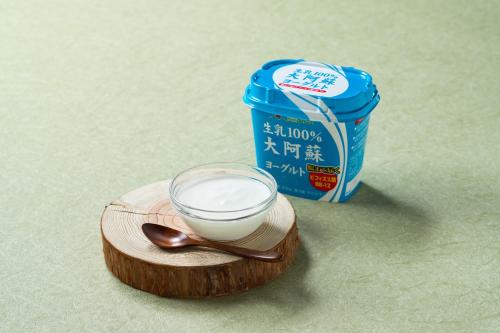 a glass bowl of milk and a spoon on a wooden plate at Vessel Hotel Kumamoto Airport in Ozu