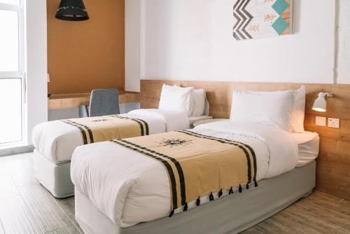Posteľ alebo postele v izbe v ubytovaní Nuzl Shada Hotel