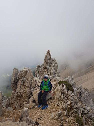 a person sitting on the top of a mountain at Obereggen - Anna in Eggen