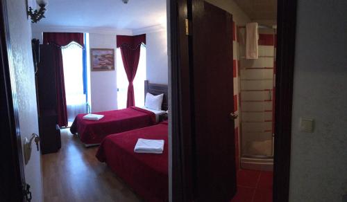 a hotel room with two beds and a window at Red White Hotel in Istanbul