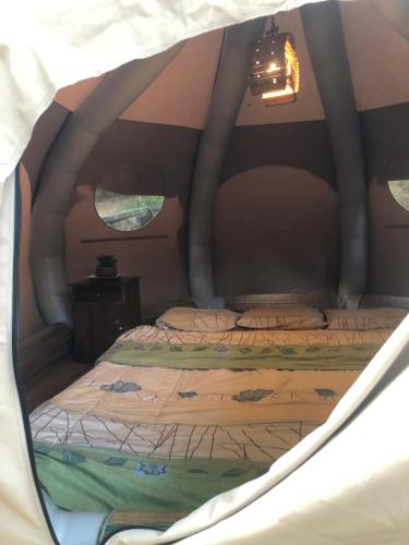 a bedroom with two beds in a tent at Surrey Bird Sanctuary & Holiday Resort in Welimada