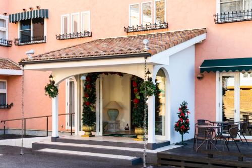 a house with a porch with christmas wreaths on it at Hotel Berlinetta Karuizawa in Karuizawa