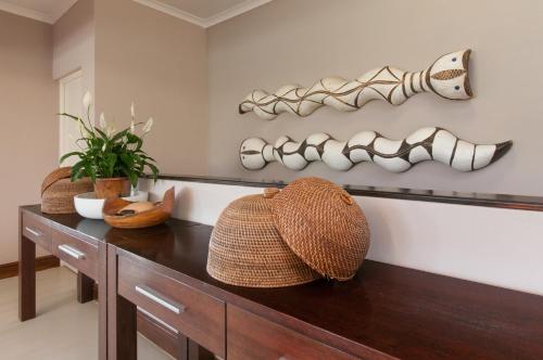 a room with a table with a hat and bowls at Whale Away Guest House in Hermanus