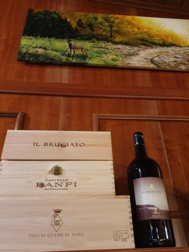 a bottle of wine sitting next to a box at Val Del Rio in Fiumalbo