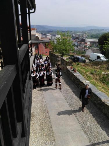 a group of people dressed in costumes walking down a street at Falagueira in Monforte de Lemos