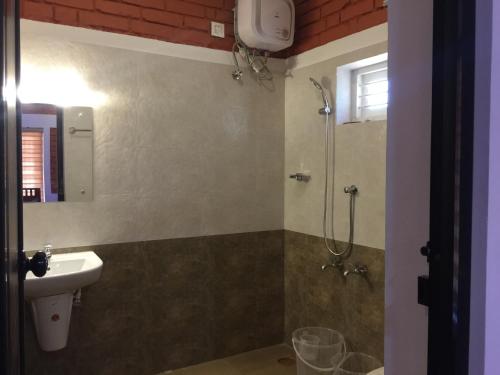a bathroom with a sink and a shower at Marsim Holiday Resort in Vythiri
