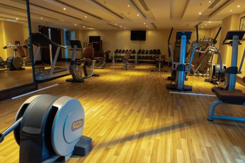 a gym with treadmills and elliptical machines at Copthorne Hotel Sharjah in Sharjah