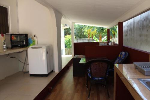 a kitchen with a table and chairs and a window at Farida Apartments in Pointe Au Sel 