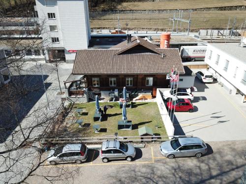 an overhead view of a building with cars parked in a parking lot at Ristorante Pensione Chalet Stazione in Poschiavo