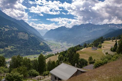a view of a valley in the mountains at Ristorante Pensione Chalet Stazione in Poschiavo