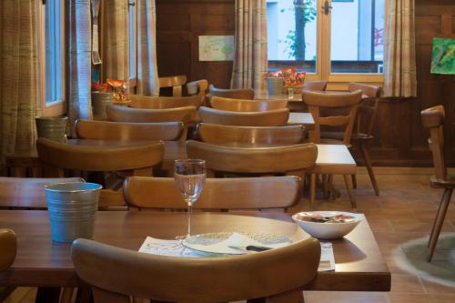 a dining room with tables and chairs and a window at Ristorante Pensione Chalet Stazione in Poschiavo