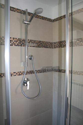 a shower with a glass door in a bathroom at Ca' Rossi in Beverino