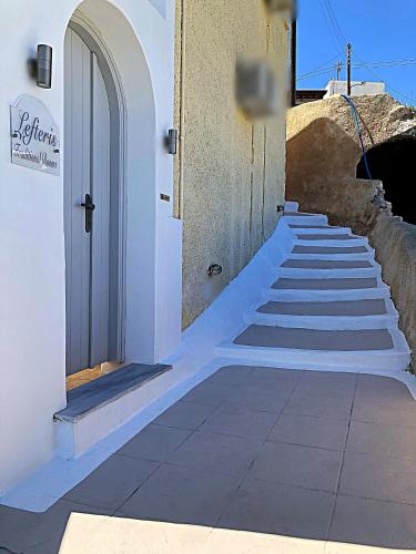 a set of stairs leading up to a building at Lefteris Traditional Rooms in Fira