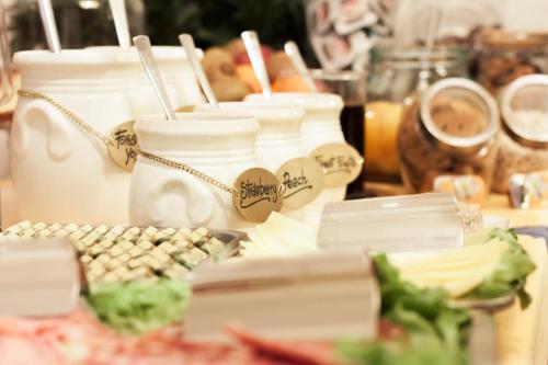 a table topped with white jars and a keyboard at Hotel Rex in Florence