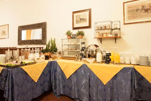 a table with a yellow and blue table cloth at Hotel Rex in Florence