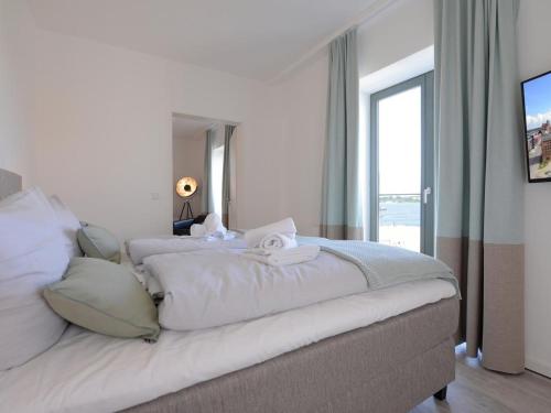 Ένα ή περισσότερα κρεβάτια σε δωμάτιο στο Meerblickzimmer Ohlerich Speicher Appartement 13