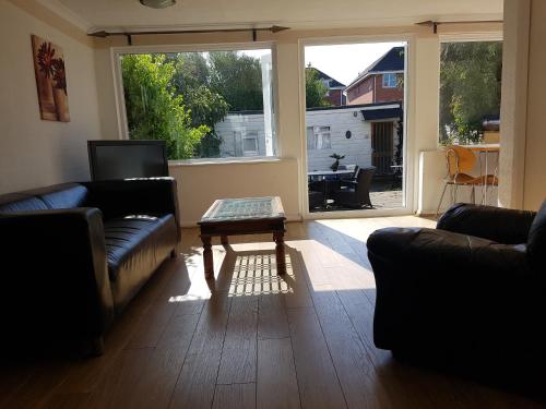 a living room with two couches and a coffee table at Boscombe Reef Hotel in Bournemouth