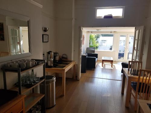 a living room with a sink and a mirror at Boscombe Reef Hotel in Bournemouth