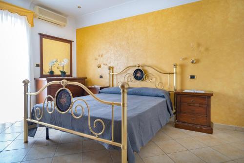 a bedroom with a bed and a wooden dresser at Casale Ceppone in Vico Equense
