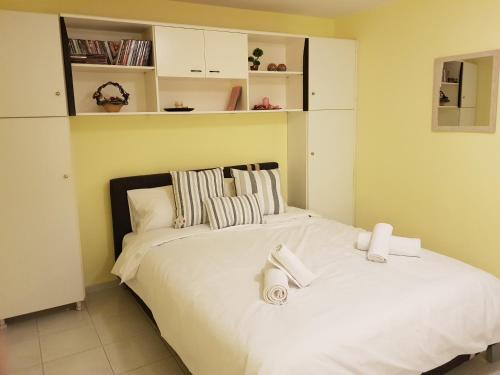 a bedroom with two beds with white sheets at COZZY STUDIO IN NEA MAKRI in Nea Makri