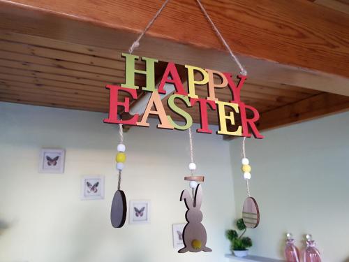 a happy easter sign hanging from a ceiling at COZZY STUDIO IN NEA MAKRI in Nea Makri