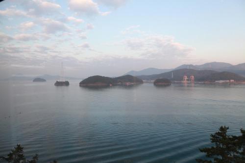 a view of a large body of water with islands at Tongyeong Bridge Hotel in Tongyeong