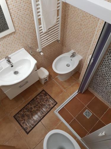 a bathroom with a sink and a toilet at Ladybianca apartment & rooms in Lecce
