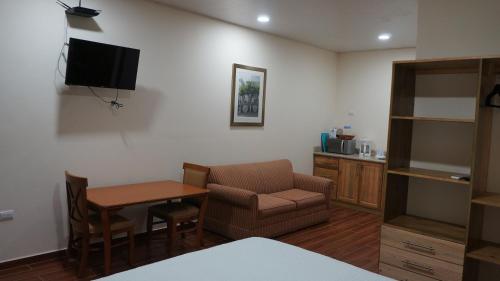 a living room with a couch and a chair and a table at Pirates Rock 101 in Utila