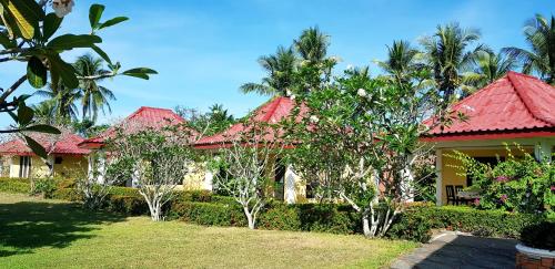 a house with a red roof and some trees at Luxor Resort in Gasan