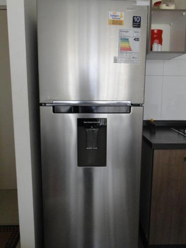 a stainless steel refrigerator in a kitchen at COSTA ALGARROBO in Algarrobo
